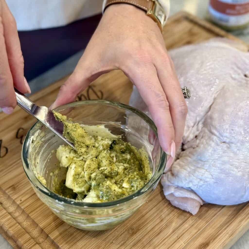 Mixing butter with poultry seasoning.