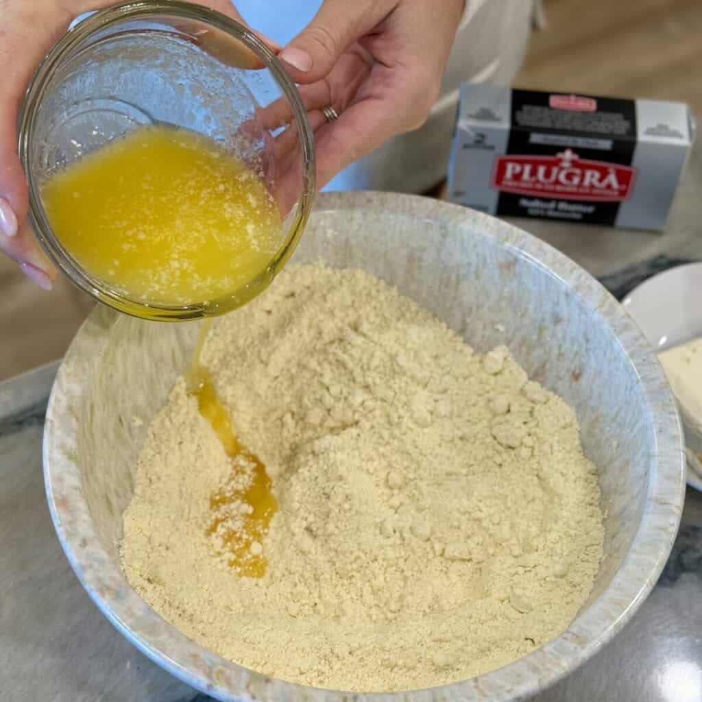 Mixing together the ingredients in a bowl for pumpkin gooey butter cake.
