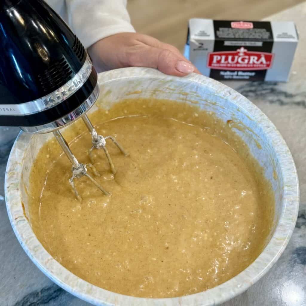 Mixing together the ingredients in a bowl for pumpkin gooey butter cake.