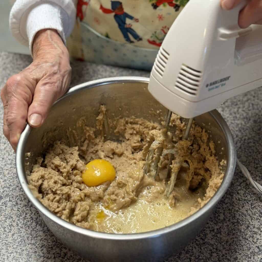 Mixing batter in a bowl for fruitcake cookies.