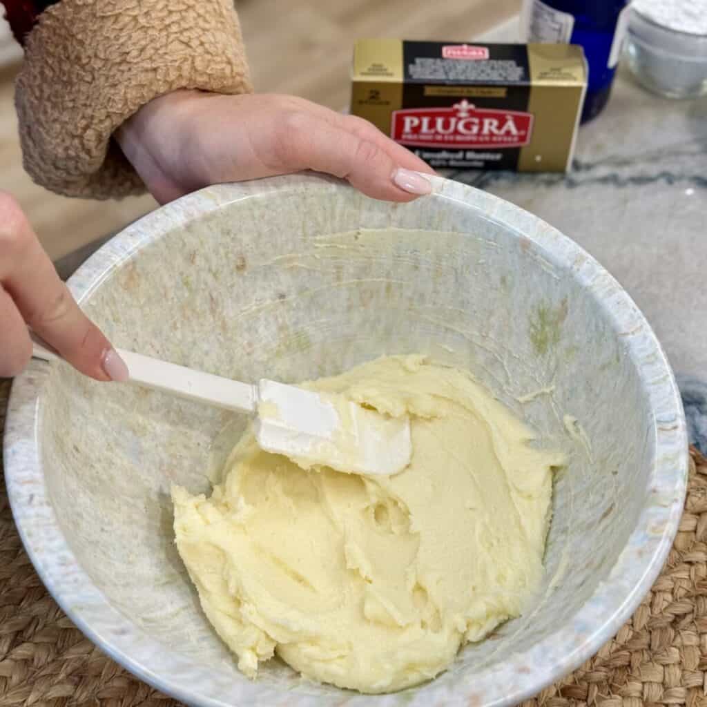 Whipping butter and sugar in a bowl.
