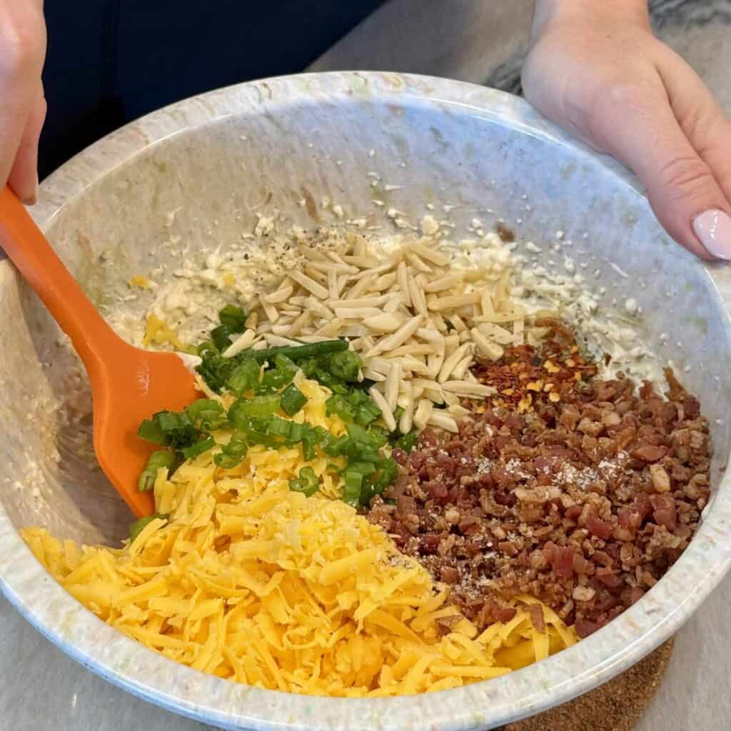 Mixing the ingredients in a bowl for million dollar dip.