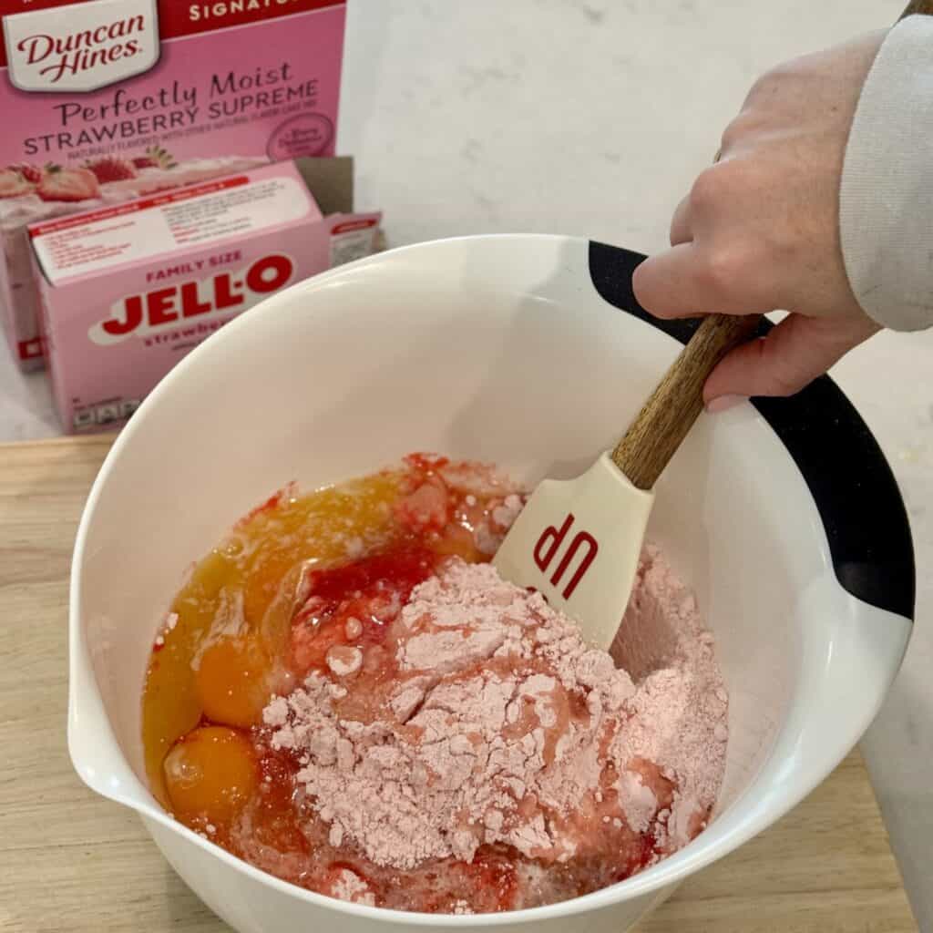 Mixing strawberry brownies in a bowl.