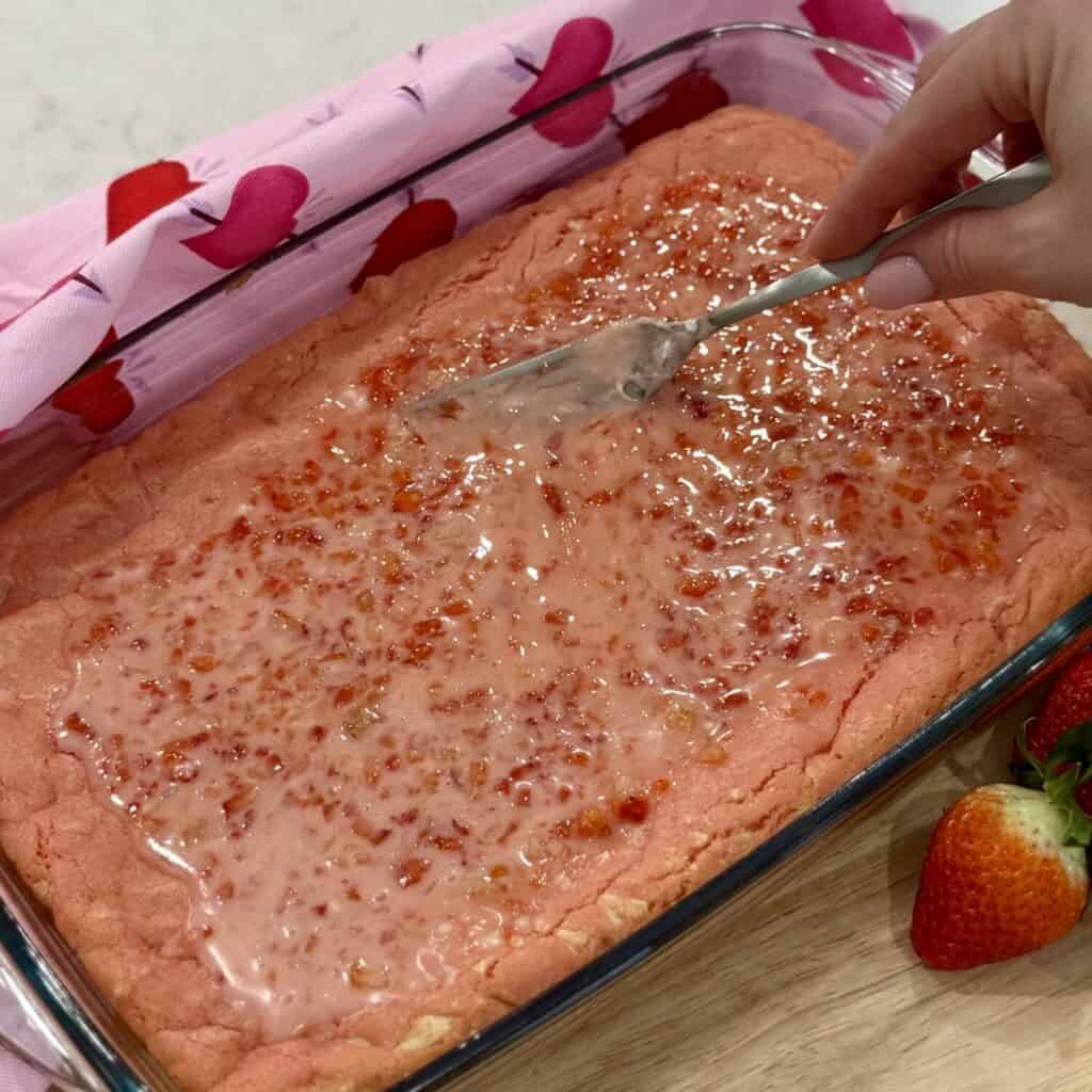 Adding topping to strawberry brownies.
