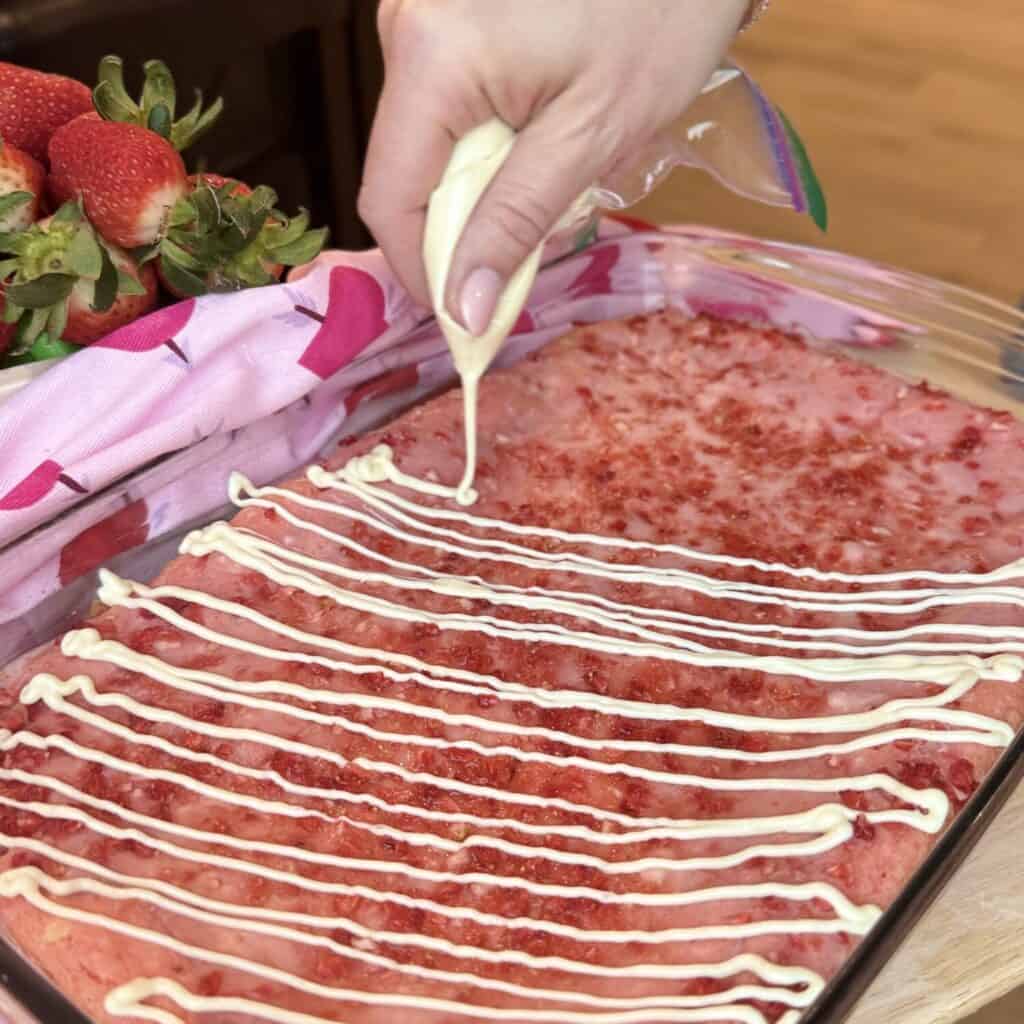 Adding topping to strawberry brownies.