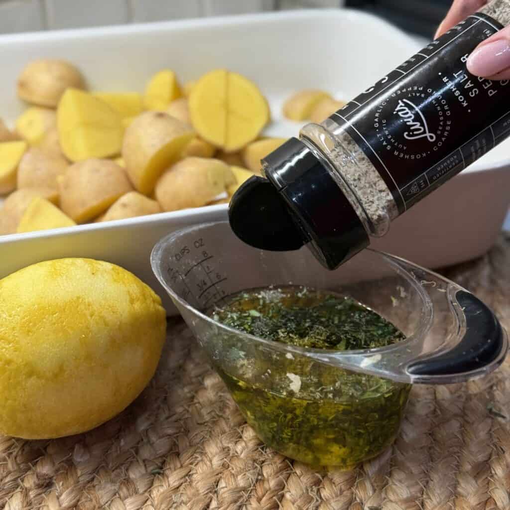 Mixing together an oil blend for potatoes.