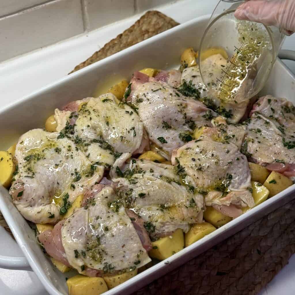 A pan of roasted chicken thighs and potatoes.