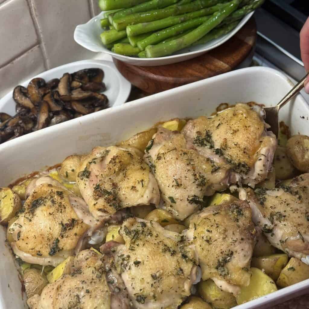 A pan of roasted chicken thighs and potatoes.