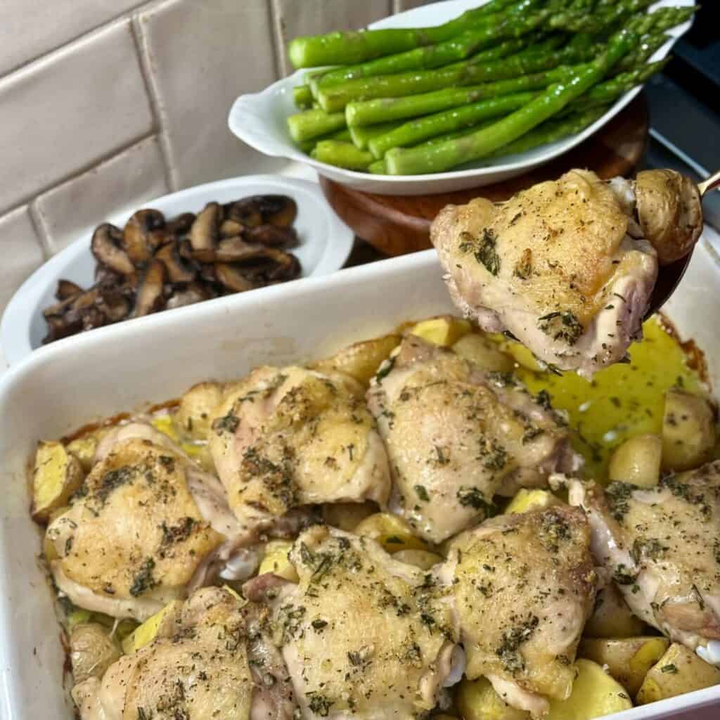 A pan of roasted chicken thighs and potatoes. 