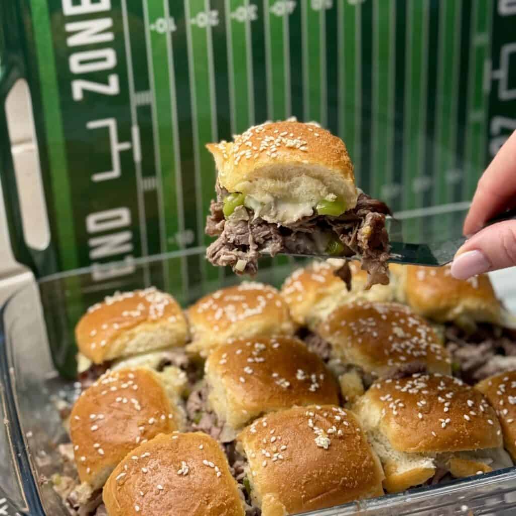 A Philly cheesesteak slider on a spatula.