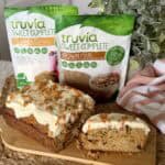 A carrot cake loaf with two bags of sweetener.
