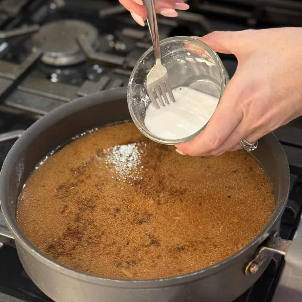 Making ham gravy in a pan.