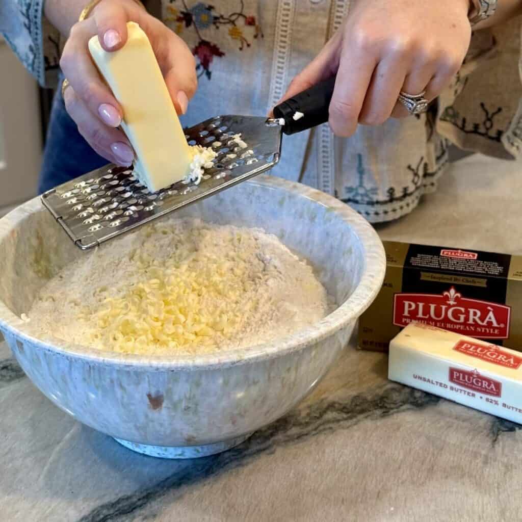 Grating butter into flour.