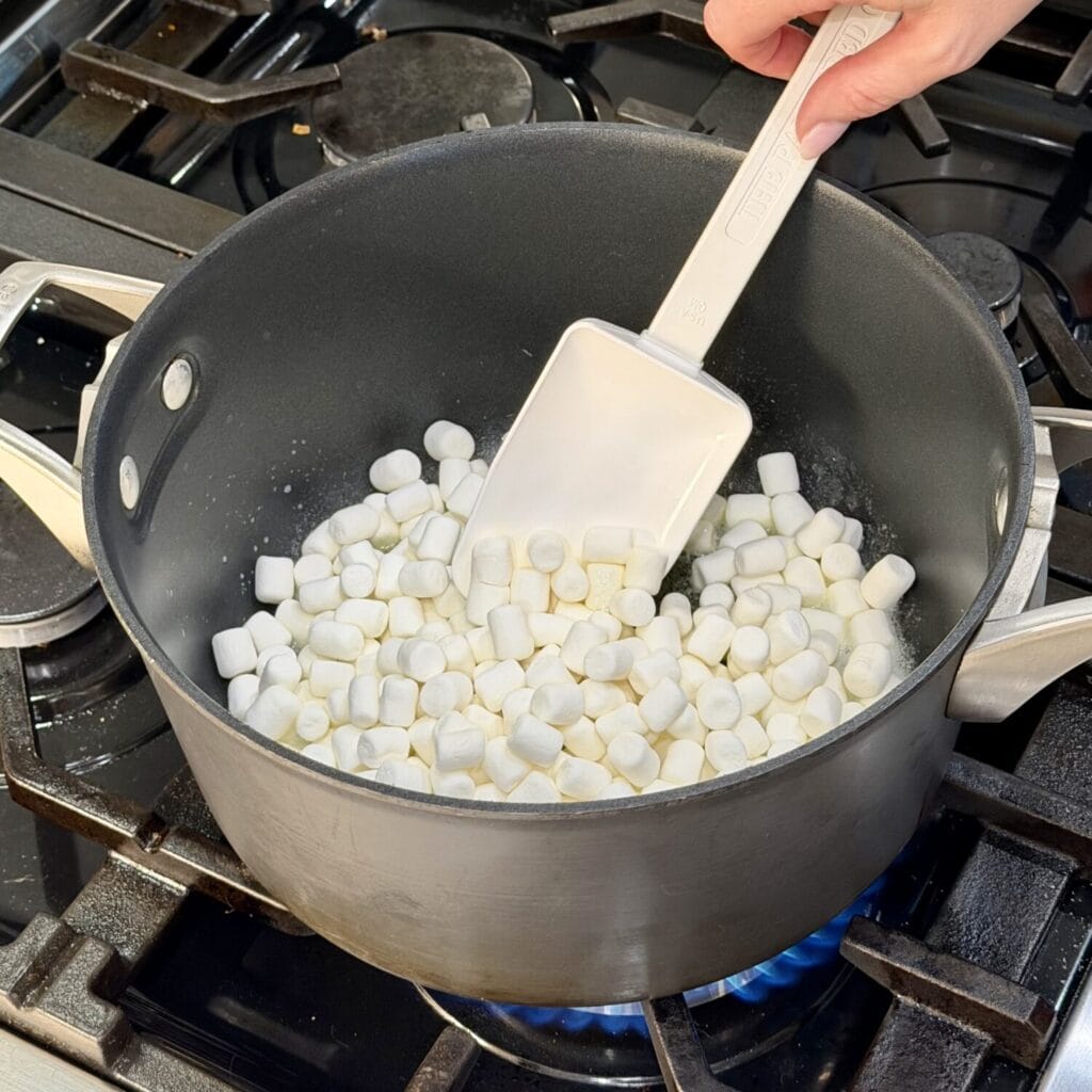 Mixing mini marshmallows on stove.