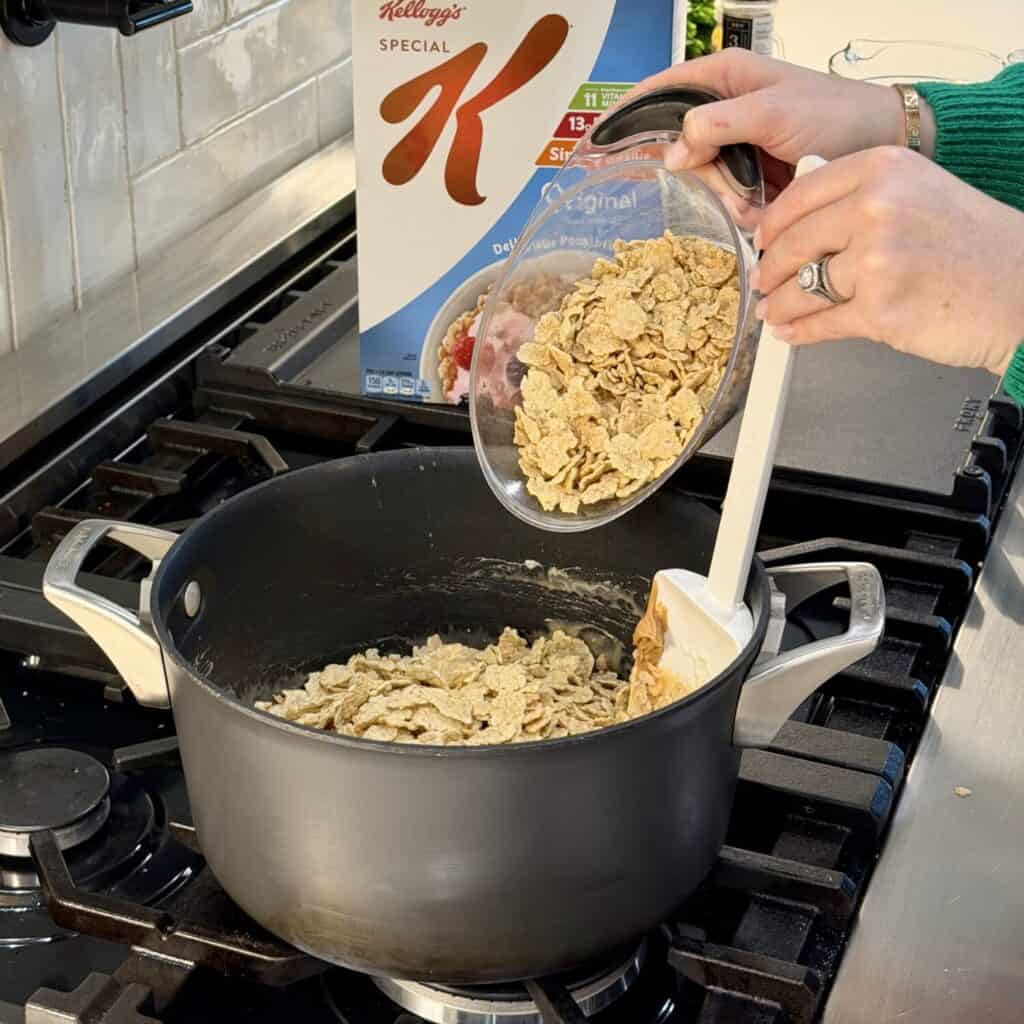 Adding in cereal to the stove.