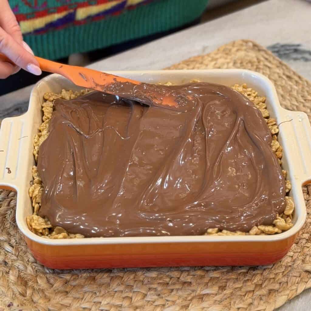 Spreading chocolate on yummy base.