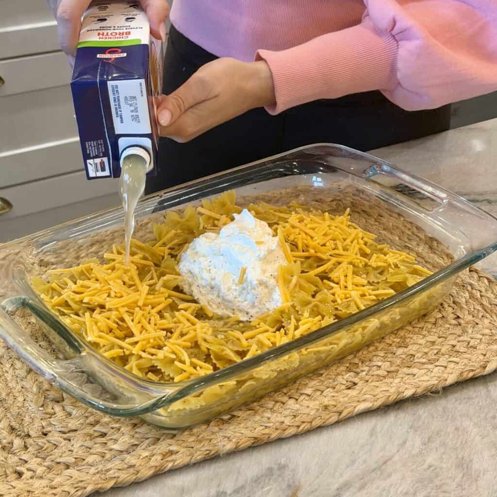 Mixing a Ham and Cheese Casserole in a pan.