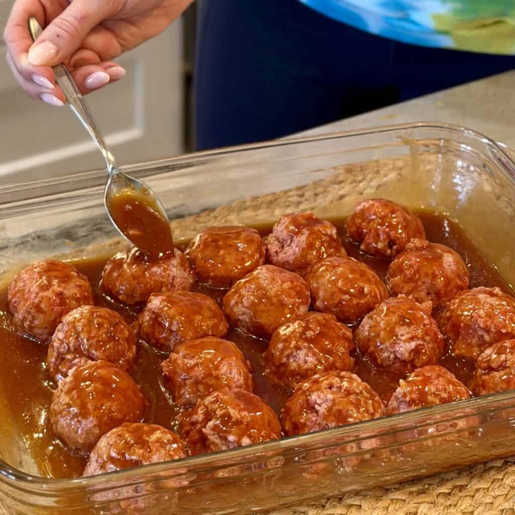 Pouring glaze over ham balls.