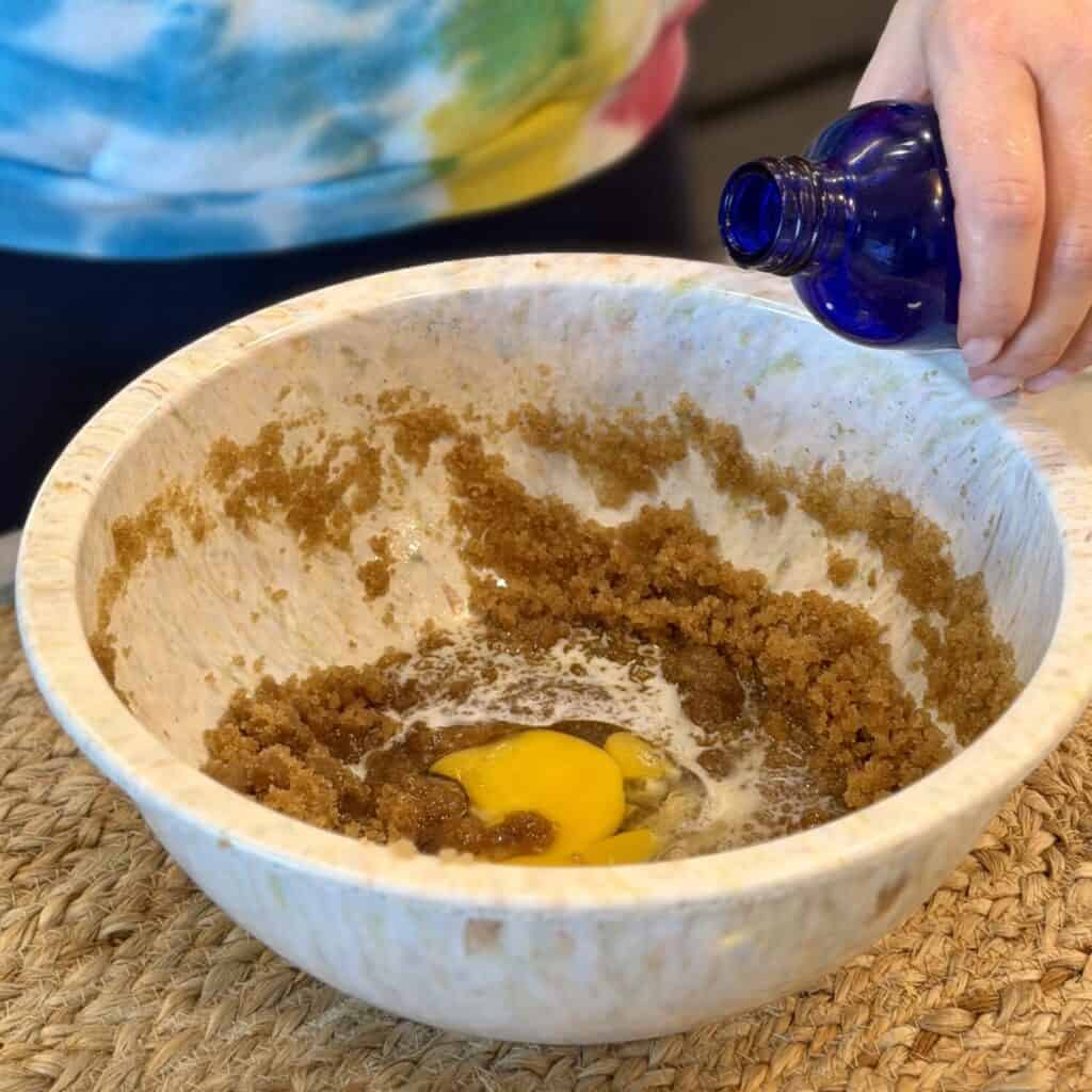 Adding in vanilla extract to the mixture.