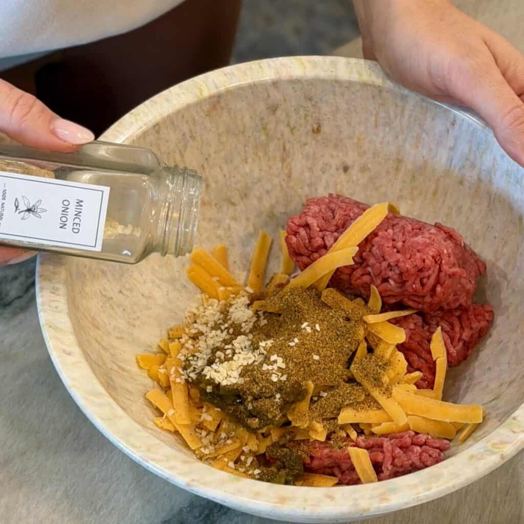 Mixing sheet pan tacos filling in a bowl.