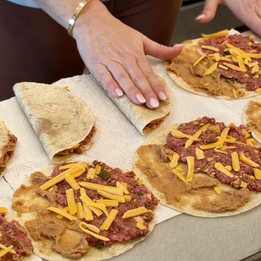 Assembling sheet pan tacos.
