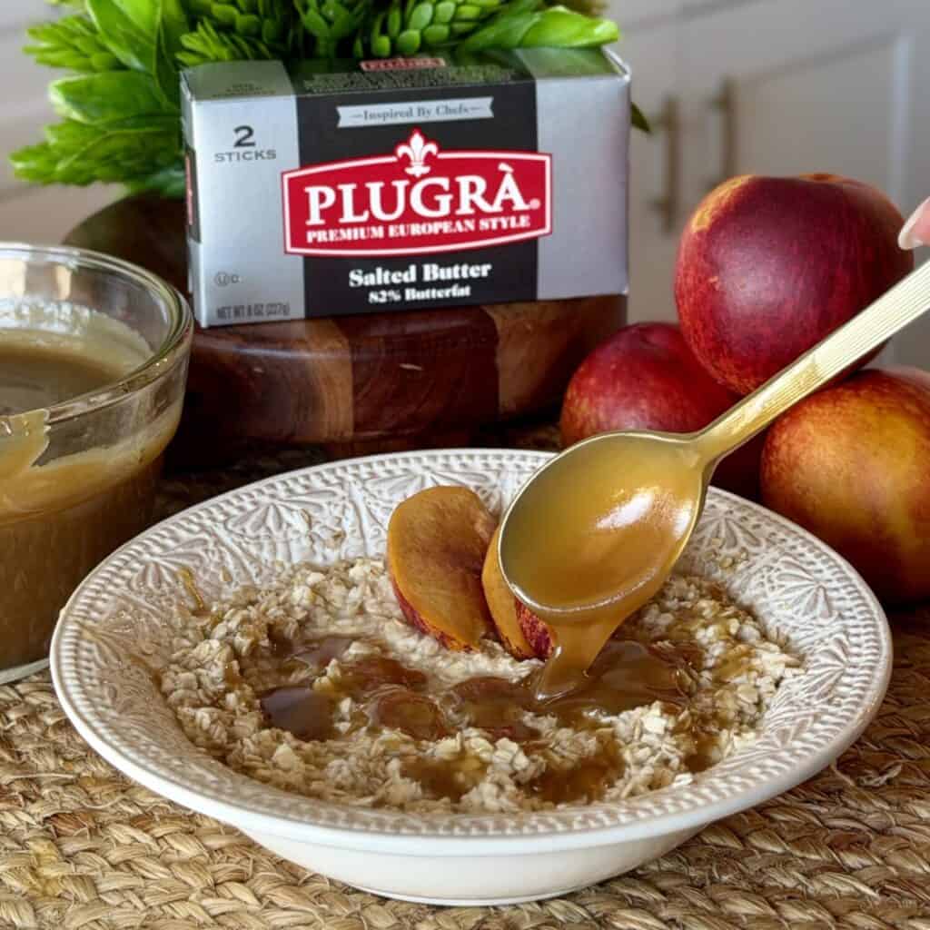 Brown sugar butter sauce being poured over oatmeal.
