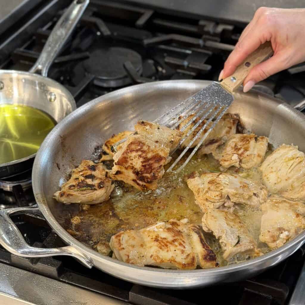 Cooking chicken in a skllet.