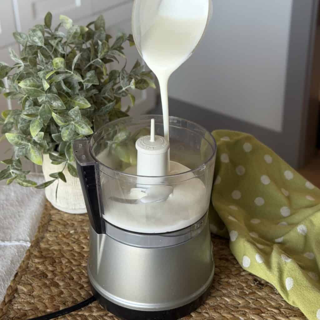 Making dressing in a food processor for a green goddess salad.