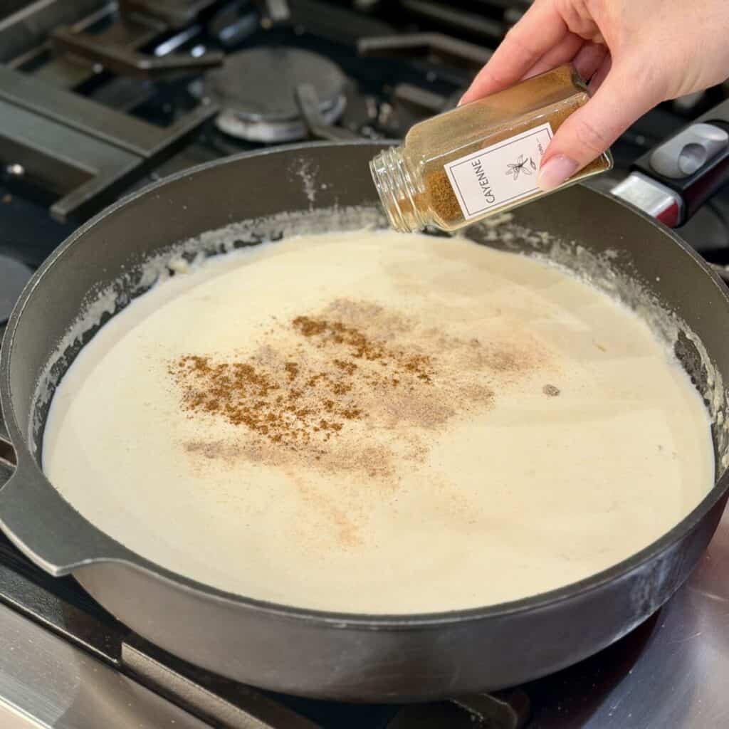 Seasoning the Mac and cheese sauce.