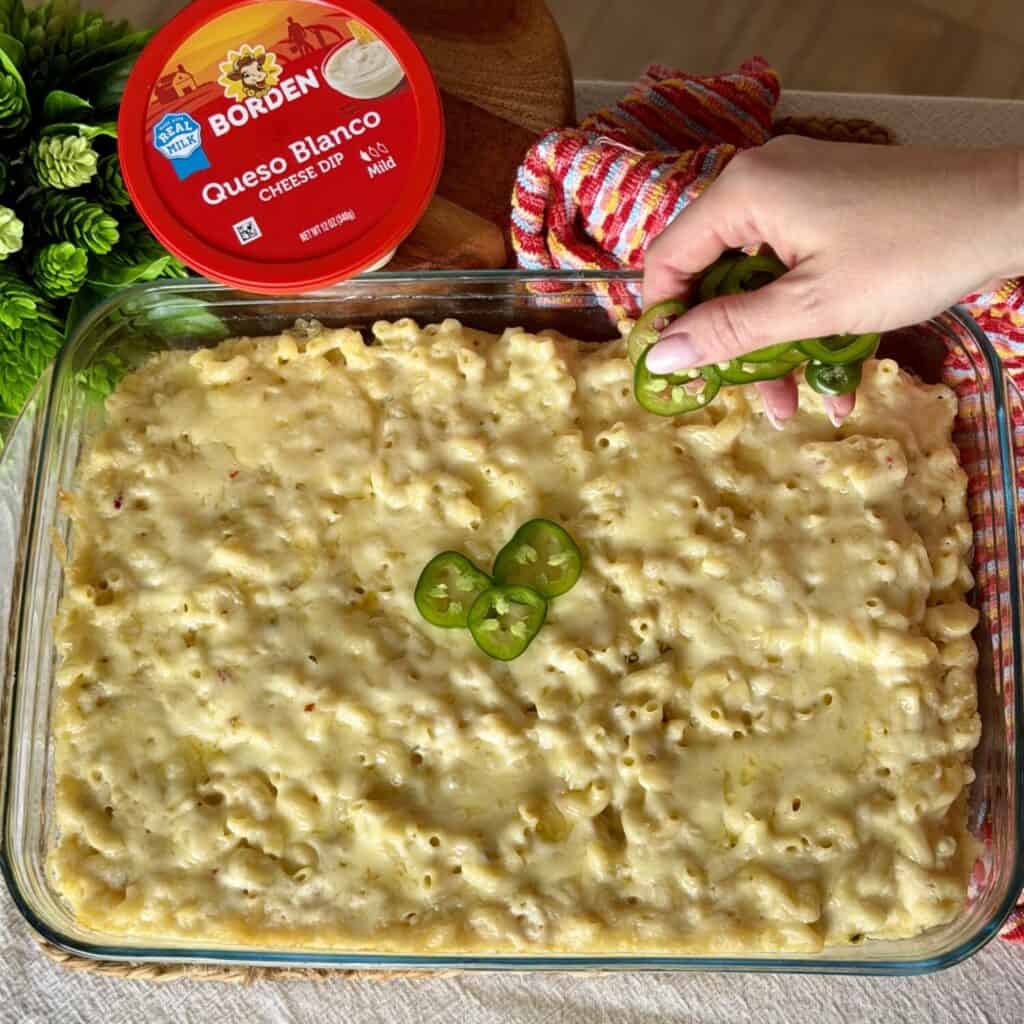 Topping Mac and Cheese off with Jalapeños.