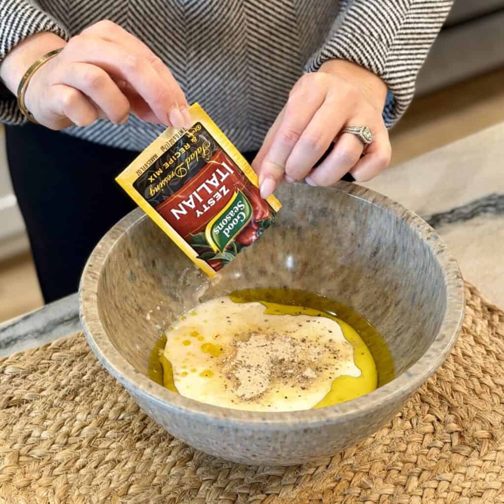 Mixing a marinate for chicken in a bowl.