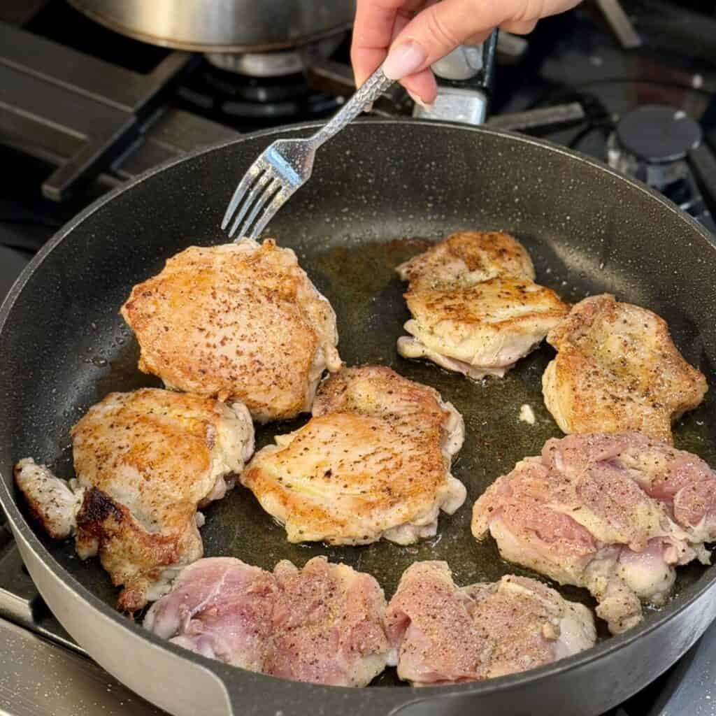 Frying chicken on a pan.
