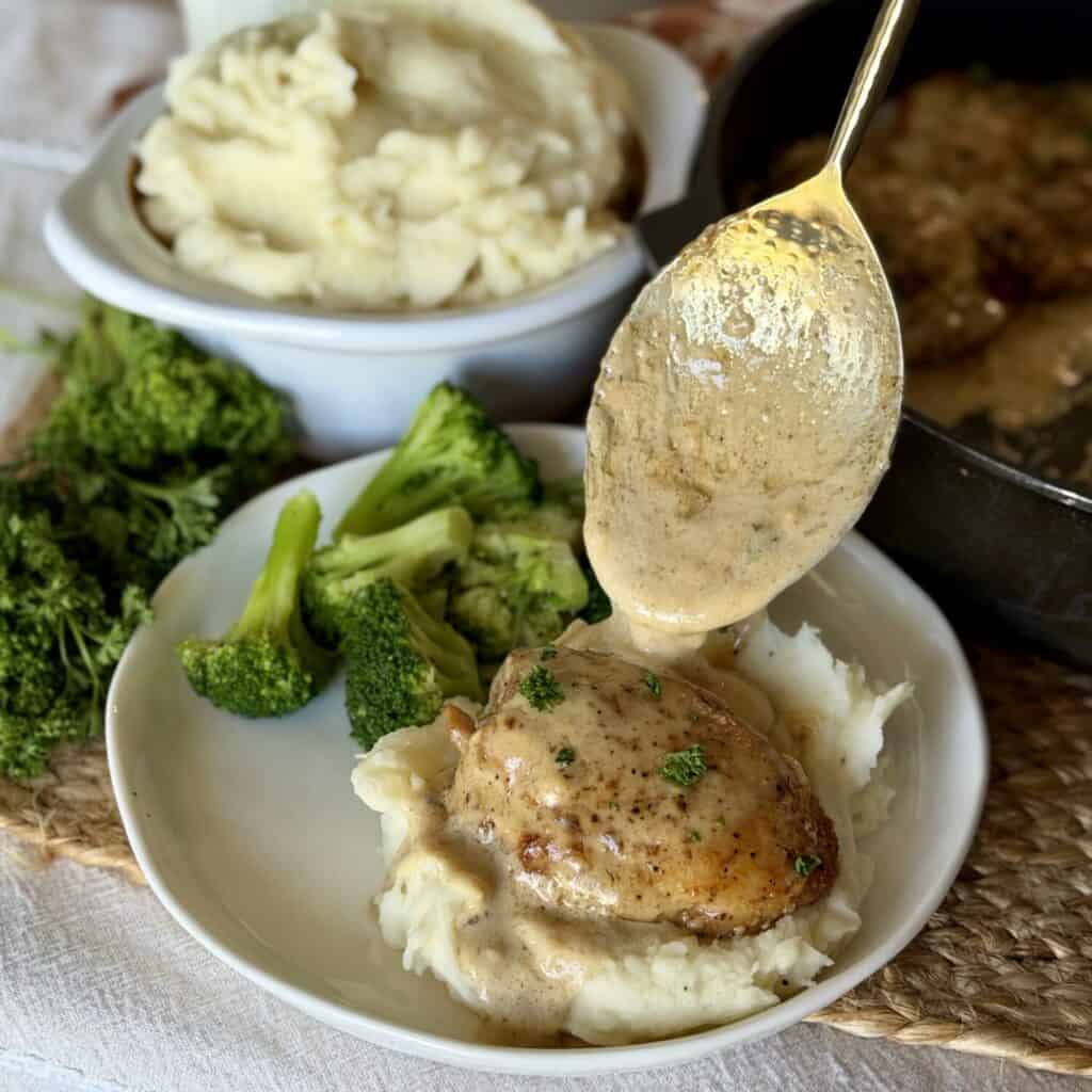 Spooning Sauce on the chicken.