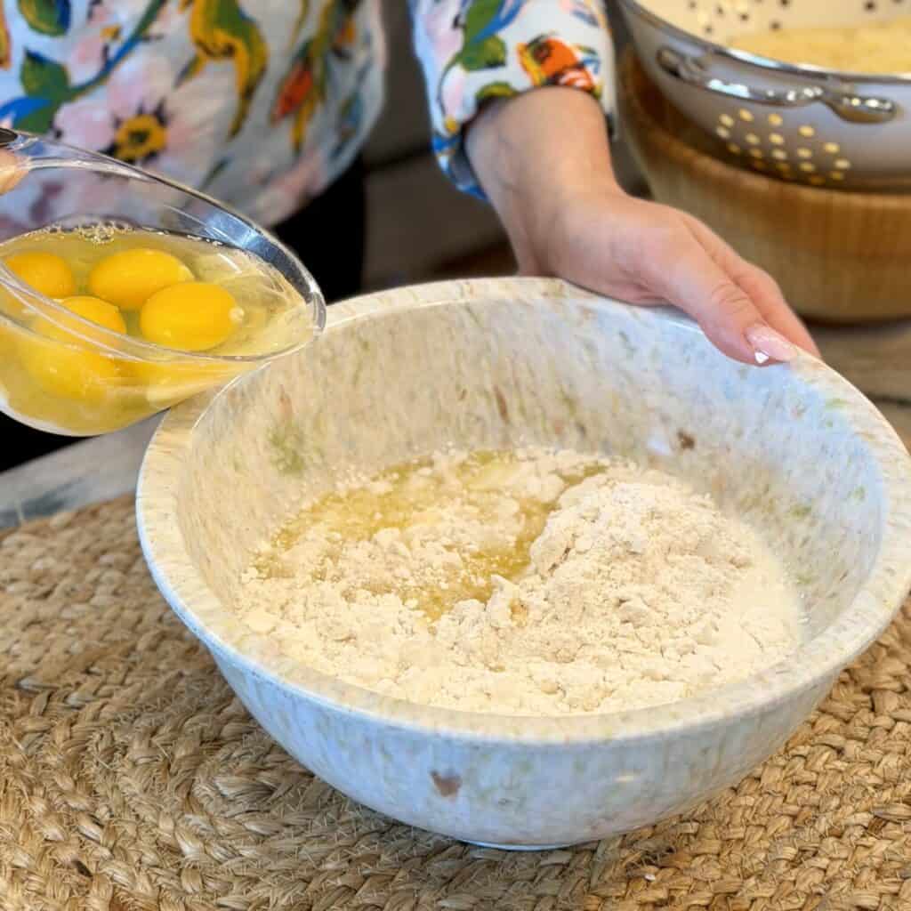 Mixing eggs into cake mixture.