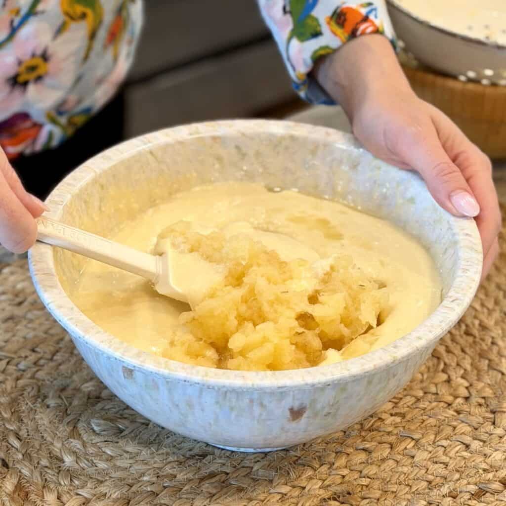 Mixing pineapple into mixture.