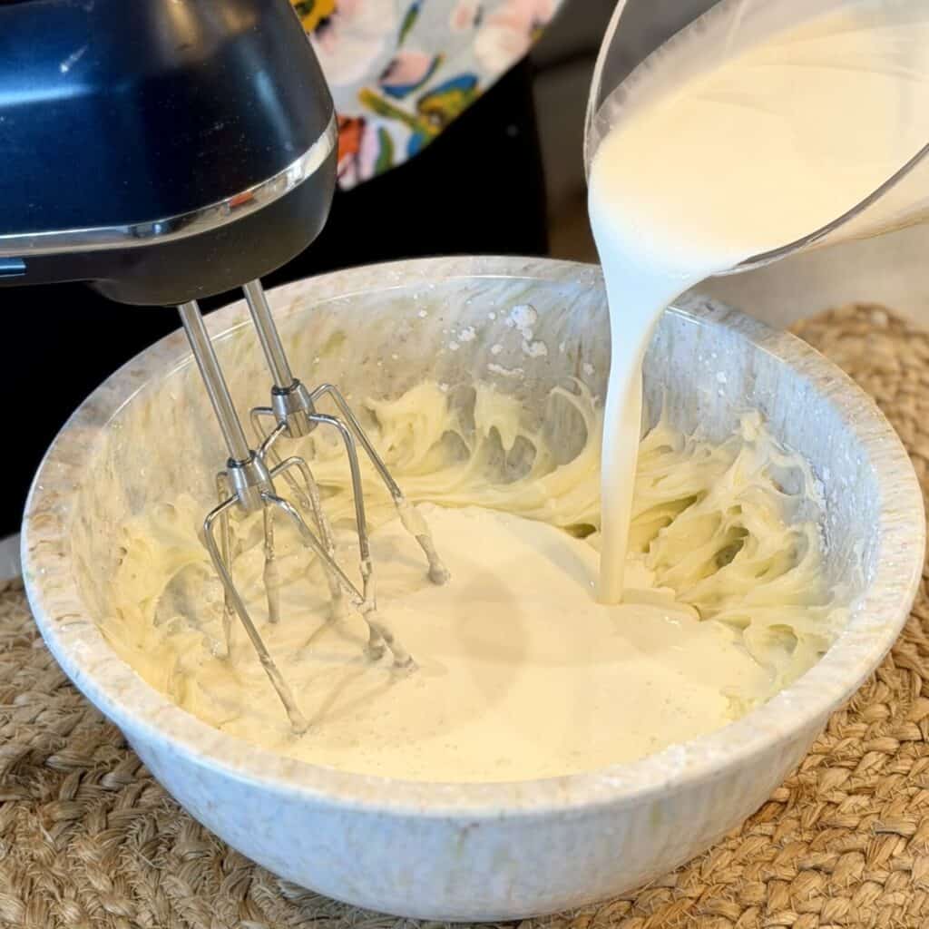 Adding whipping cream to cream.