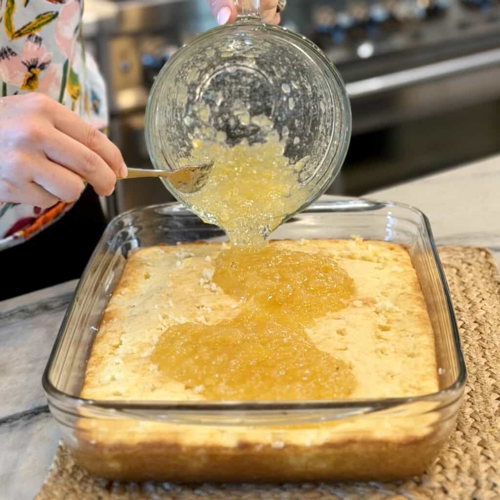 spreading pineapple sauce to cake.