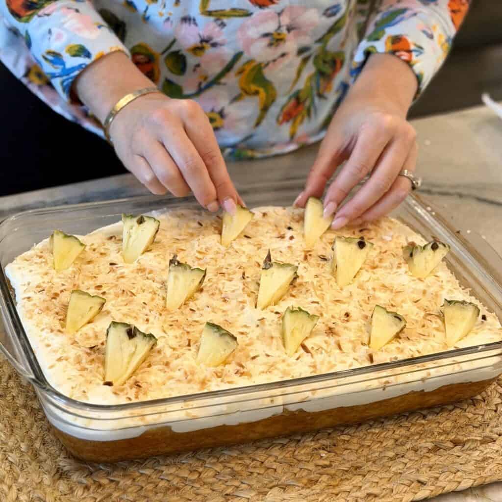 Adding pineapple to the cake.