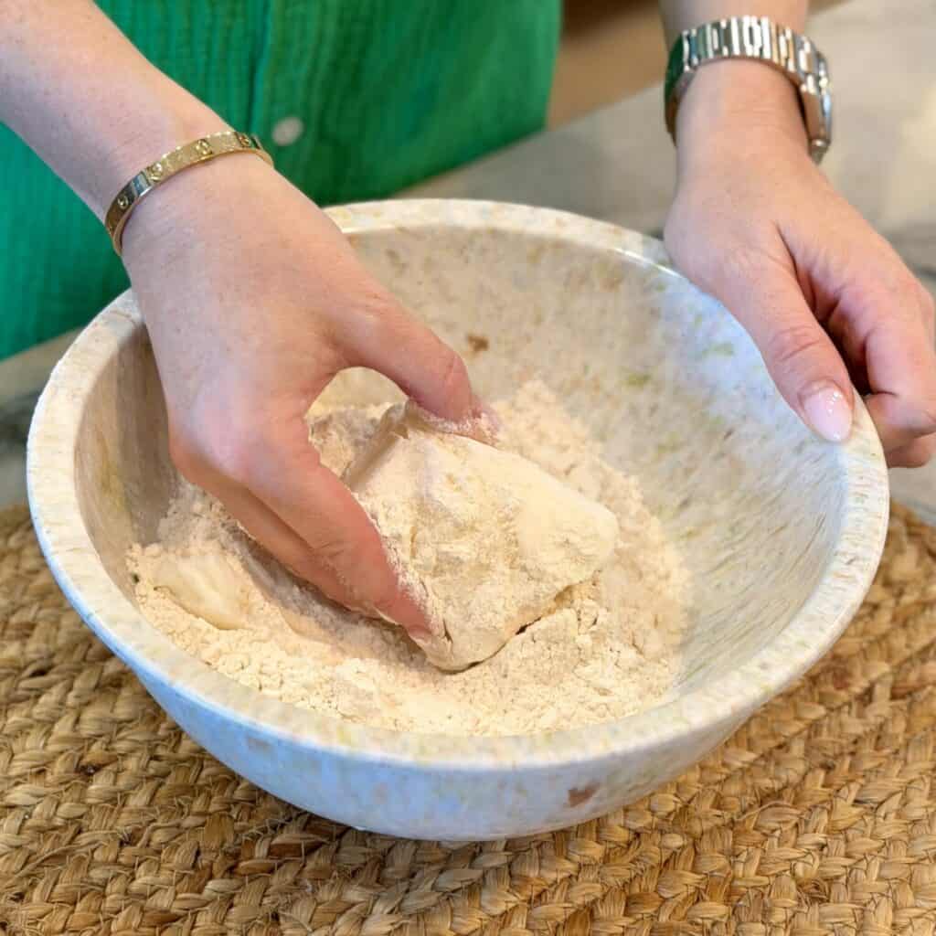 Adding lard into dry ingredient Bowl.