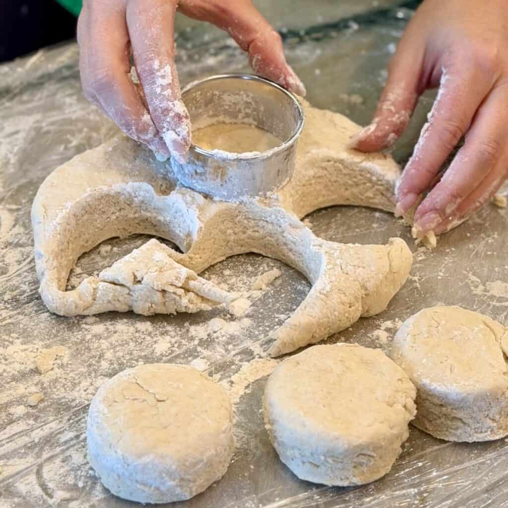 Shaping the dough into biscuits.