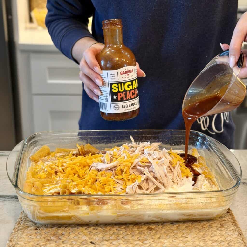 Adding barbecue sauce to the dish.