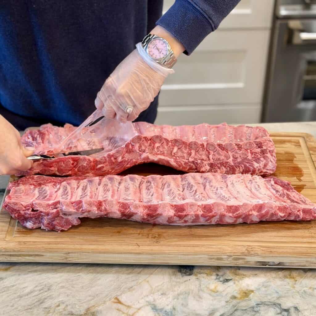 Peeling silver skin off the ribs.