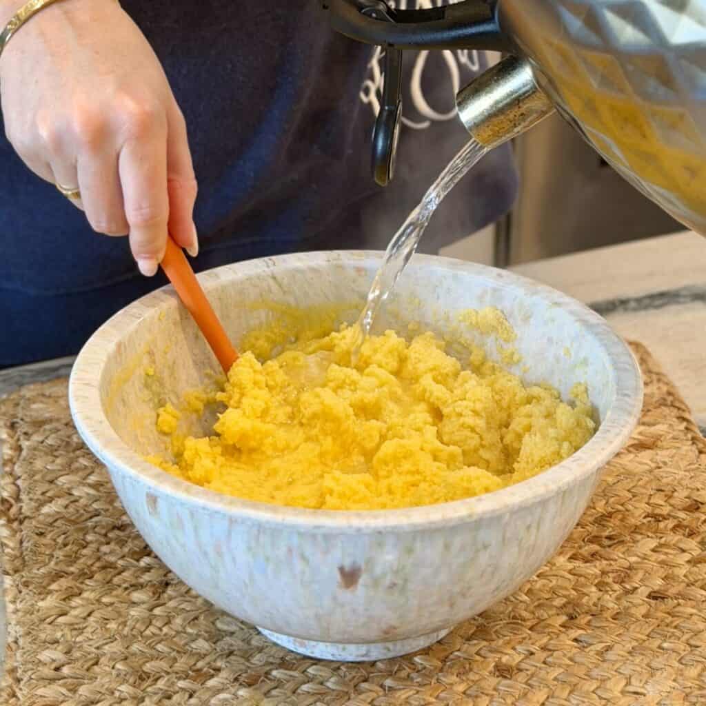 Adding Hot water to the cornbread mixture.