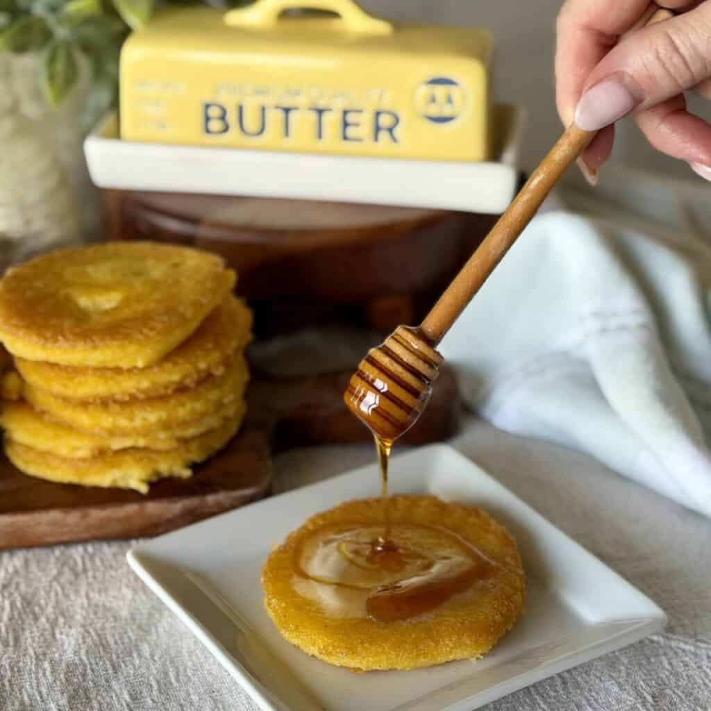 Drizzling honey to Hot Water Cornbread.