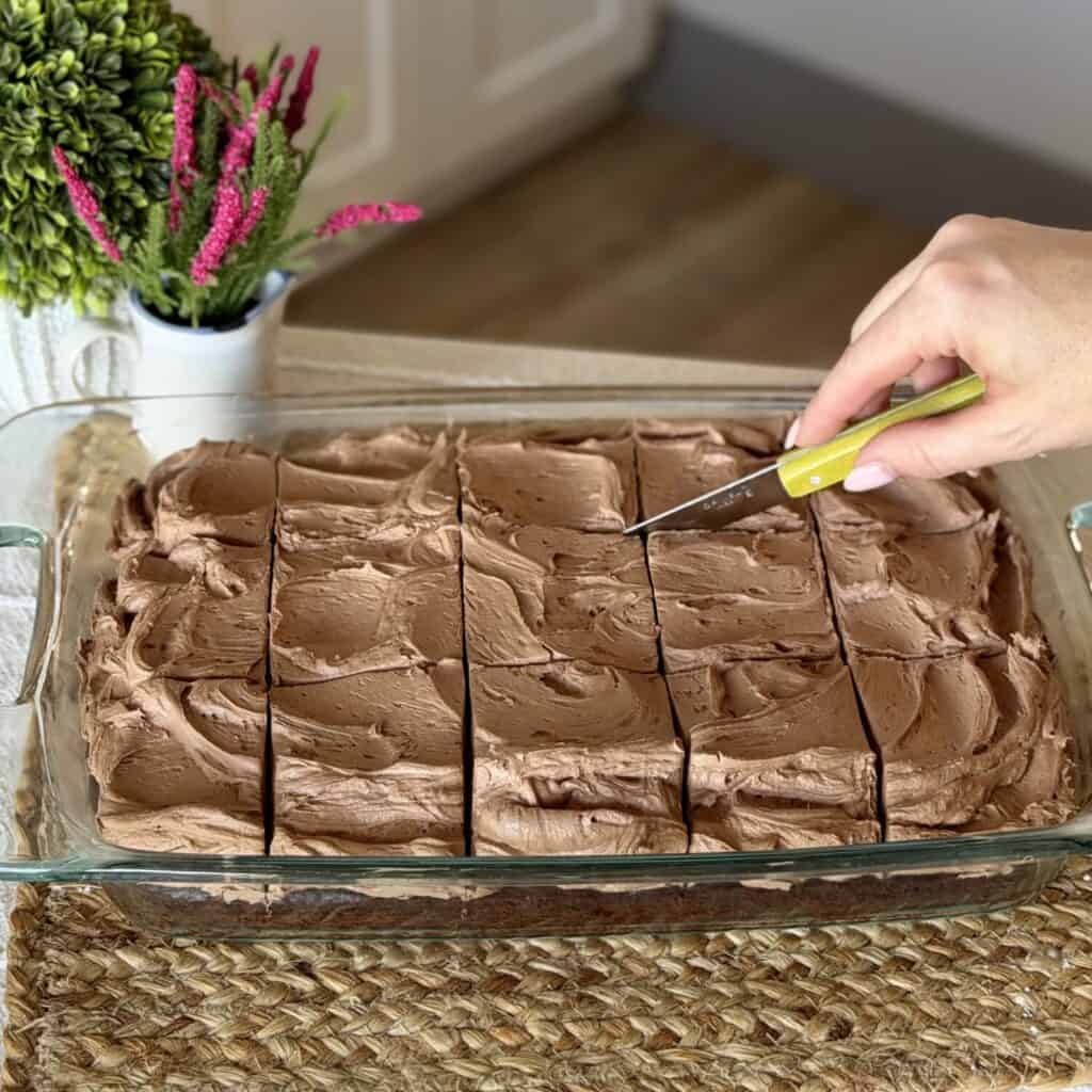 Slicing the dish of Chocolate Mayonnaise Cake.