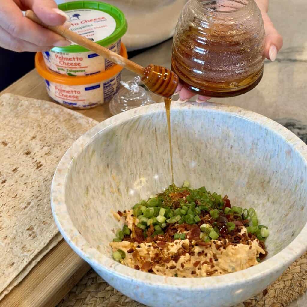 The ingredients in a bowl for pimento cheese pinwheels.