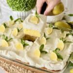 Holding a slice of lemonade cake.