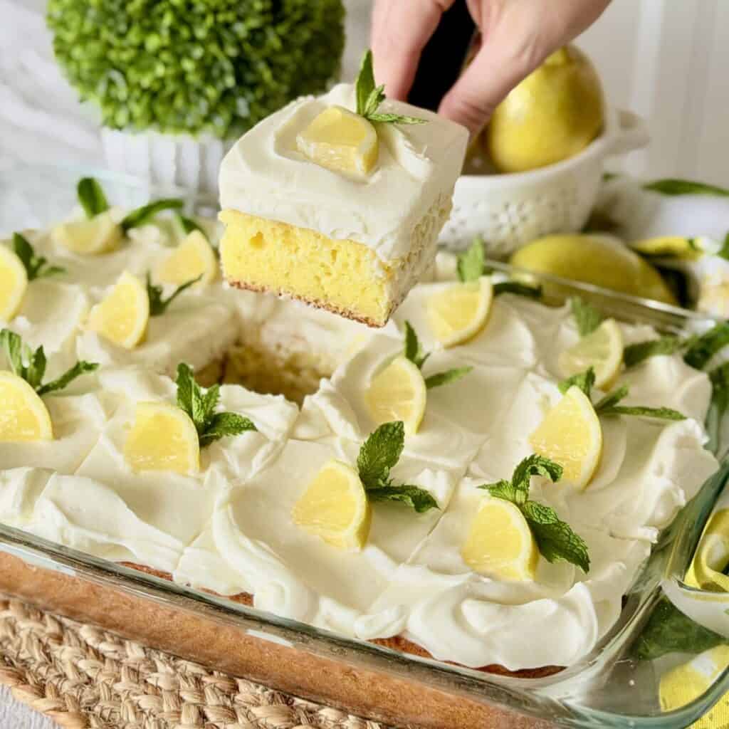 Holding a slice of lemonade cake.