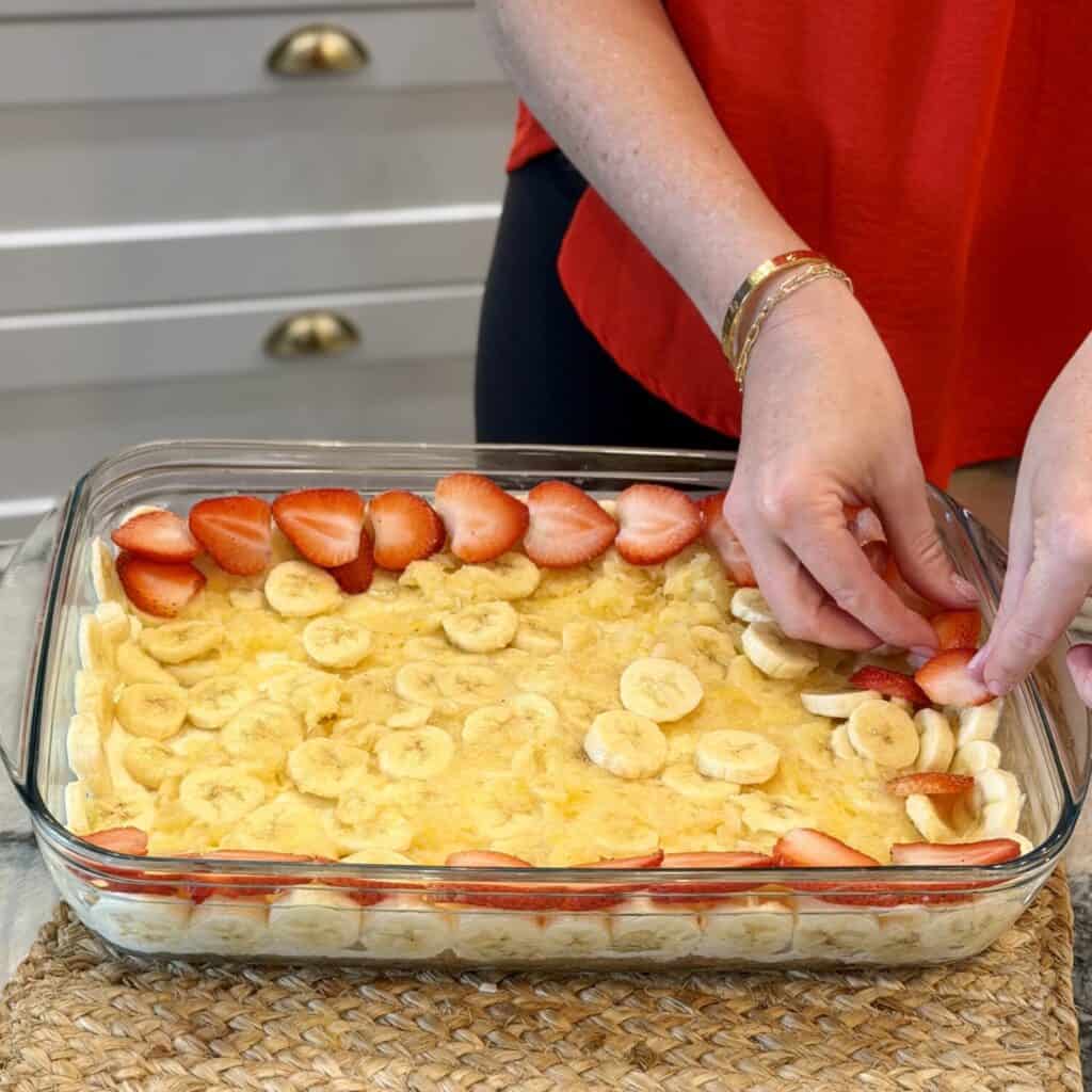 Laying the strawberries and bananas on top.