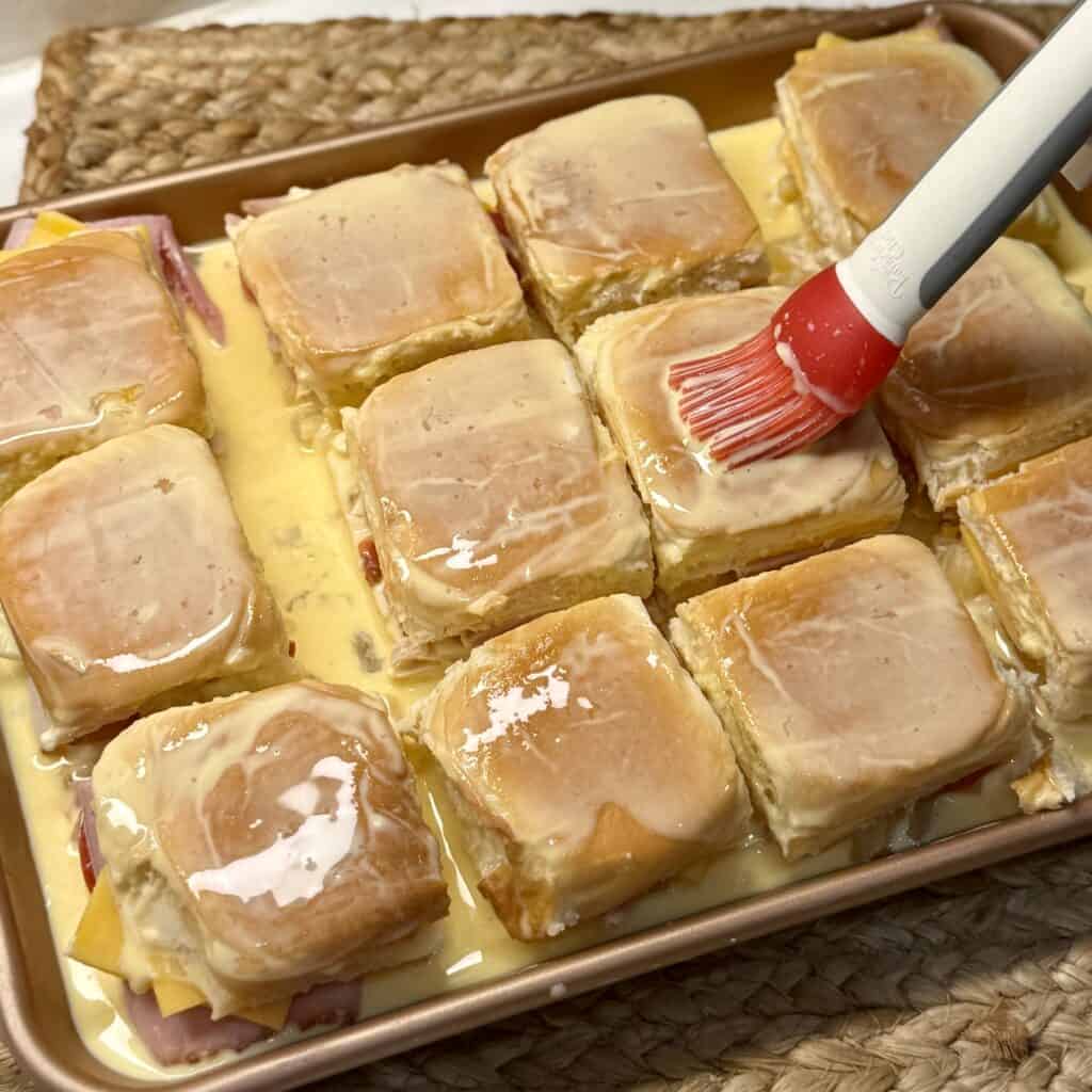 Adding the egg mixture to the sliders.